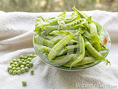 Green peas. Hulk pods in a glass bowl Stock Photo