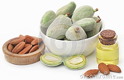 Green and peeled almond and essential oil Stock Photo