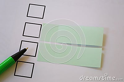 Green pen pointing empty checkbox and have blank paper note. Stock Photo