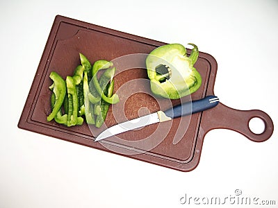 Green pepper fruit lies on the cutting Board Stock Photo