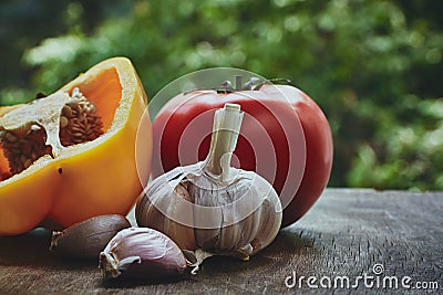 Green pepper, tomato and garlic heads Stock Photo