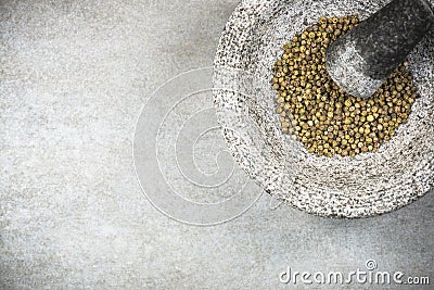 Green peppercorn seed in granite mortar or pestle Stock Photo