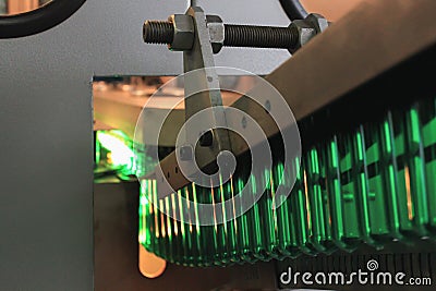 Green pet plastic bottle preforms on the conveyer. Concept of bottled mineral water production Stock Photo