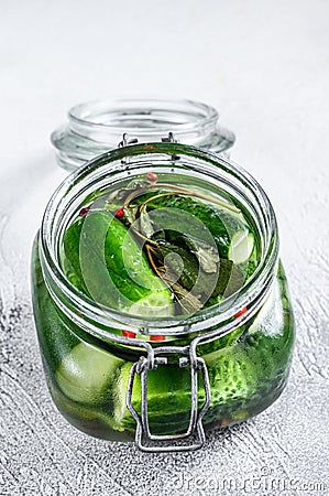 Green pickle cucumbers in a glass jar. Natural product. White background. Top view Stock Photo