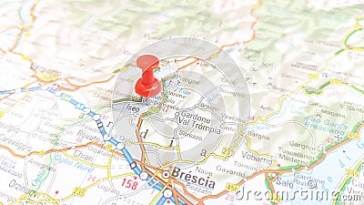 A red pin stuck in Lake Iseo on a map of Italy Stock Photo