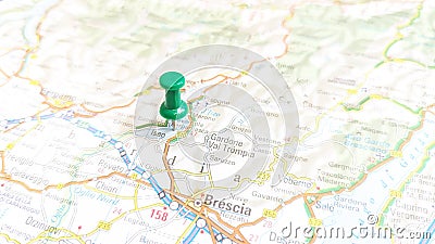 A green pin stuck in Lake Iseo on a map of Italy Stock Photo