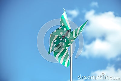 green pinwheel on sky Stock Photo