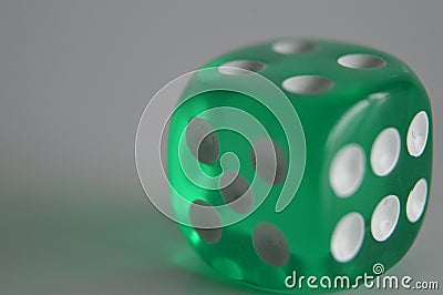 Green plastic arcylic d6 six sided die dice close up variable focus Stock Photo