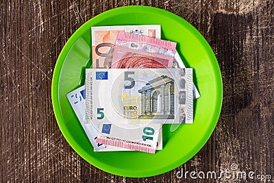 Green plate with Euro notes. Stock Photo