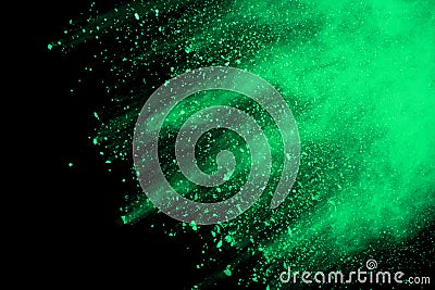 Green powder explosion on black background. Colored cloud. Colorful dust explode. Paint Holi Stock Photo