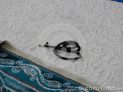 Green prayer rug and rosary. green prayer rug and ramadan month Stock Photo
