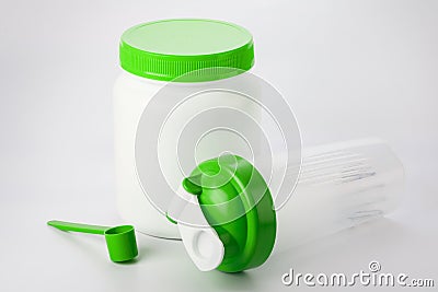 Green protein shaker, scoop and jar on white Stock Photo