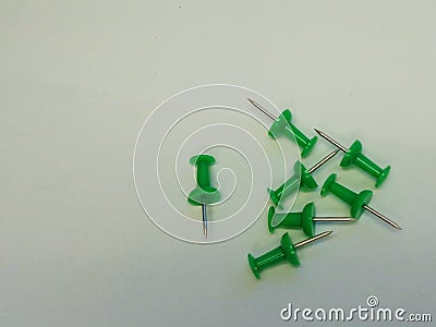 7 Green Push Pins on Grey Background Stock Photo