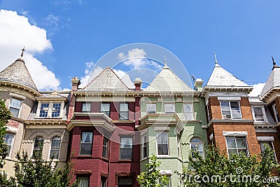 Green, red, and orange row houses in Washington DC on a summer day. Stock Photo