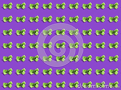 Green ribbons with shamrock on purple color background, Decoration in Irish style. Emerald island theme. Saint Patrick day Stock Photo