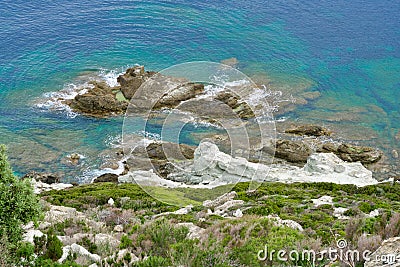 Green riff in front of a turquois sea Stock Photo