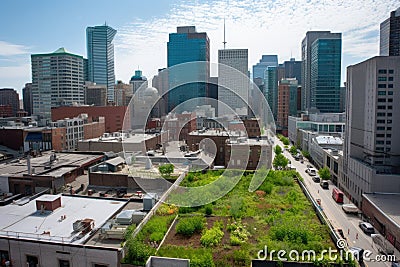 green rooftop with view of a bustling cityscape, including tall buildings and busy sidewalks Stock Photo