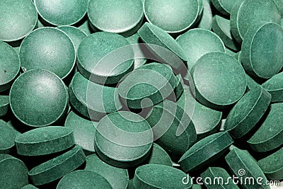 Green round healthy pills macro medical spirulina platensis space food modern high quality instant prints tablets background top Stock Photo