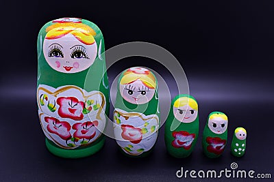 Green russian national Matrioska toy on dark background Stock Photo