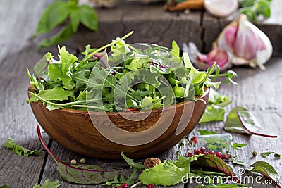 Green salad leaves in a wooden bowl Stock Photo