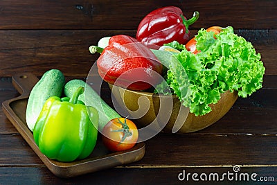 A green salad in wood cup consisting of a mixture of small usually Green leafy vegetable, Various kinds of vegetables Stock Photo