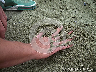 Hand on a green sand Stock Photo
