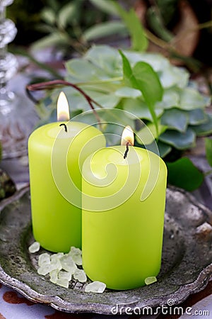 Green scented candles on silver plate Stock Photo