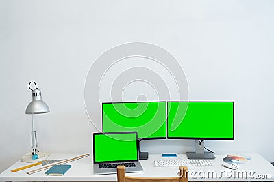 Green screen monitor stands on the office desk - Personal compute mock-up. Editorial Stock Photo