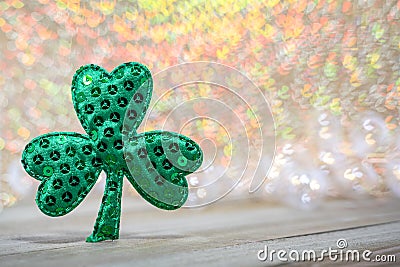 Green sequin shamrock for St. Patricks Day on wooden board Stock Photo