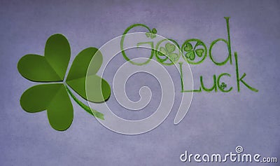 Green shamrock and wish good luck on white. Stock Photo