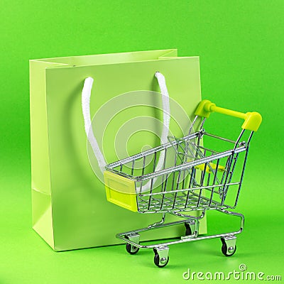 Green shopping cart and gift bag Stock Photo