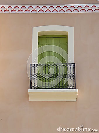 Green shuttered window and balcony Stock Photo