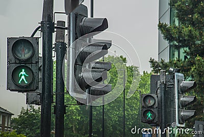 Green signs for people crossing the road On a rainy day Stock Photo