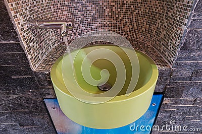 Green sink or washbowl with water tap with mosaic Stock Photo