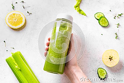 Green smoothie bottle in hand Stock Photo