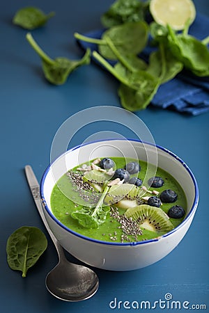 Green smoothie bowl spinach kiwi blueberry banana with chia seed Stock Photo
