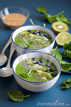 green smoothie bowl spinach kiwi blueberry lime banana with chia seed Stock Photo