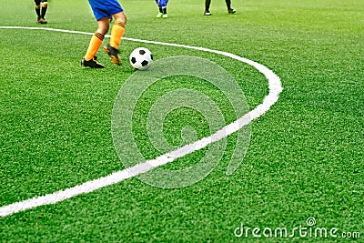 Green soccer field grass with white mark line and the boys play football Stock Photo