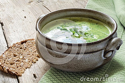 Green soup with broccoli, arugula and spinach in a ceramic bowl Stock Photo