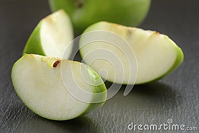 Green sour apple on slate board sliced Stock Photo