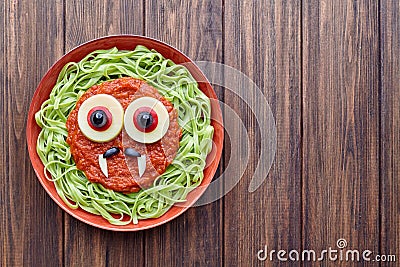 Green spaghetti pasta spooky halloween vegetarian food vampire monster Stock Photo