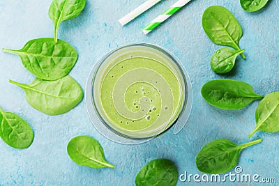 Green spinach smoothie on blue table top view. Detox and diet food for breakfast. Stock Photo