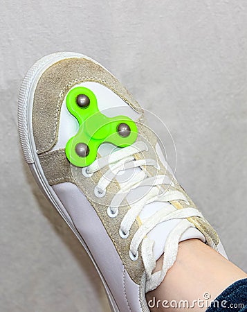 Green spinner spin on your foot on a sneaker Stock Photo