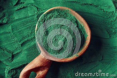 Green spirulina algae powder on a spoon Stock Photo