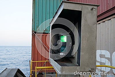 Green starboard side navigational lights of the loaded container ship. Editorial Stock Photo