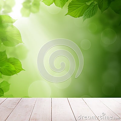 Green summer leaves and abstract bokeh light with white wooden board background Stock Photo