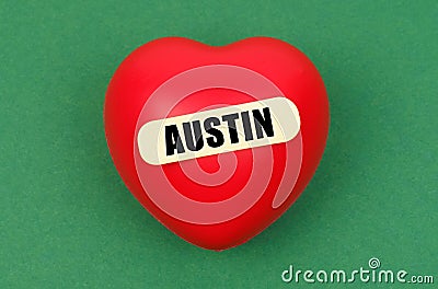 On a green surface lies a red heart with the inscription - Austin Stock Photo