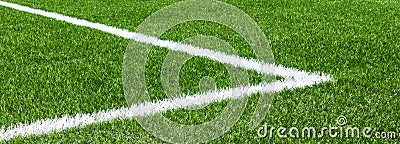 Green synthetic artificial grass soccer sports field with white corner stripe line Stock Photo