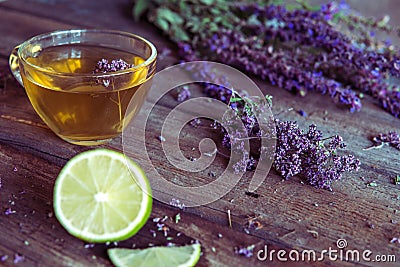 Green tea with herbals and lime. Tea with oregano on the wooden Stock Photo