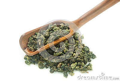 Green tea leaves and wooden scoop Stock Photo